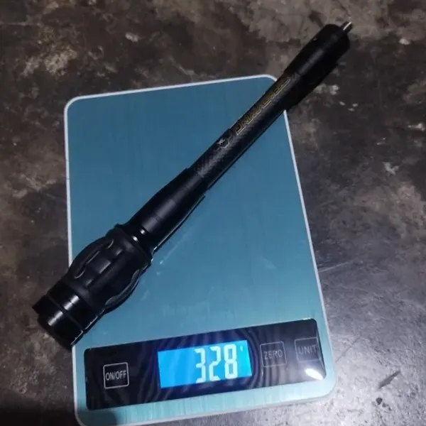 Bow stabilizer on a kitchen scale reading 328 grams — unedited verified buyer photo (Malaysia)